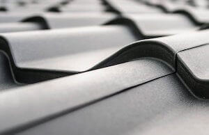 Closeup of grey steel roof shingles.